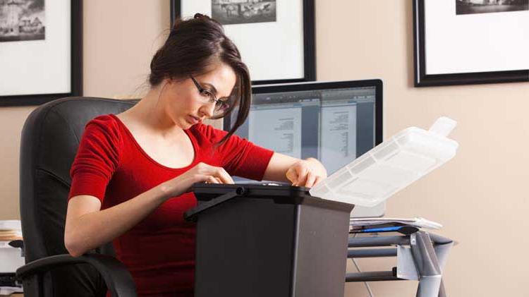 Woman putting documents into a box.